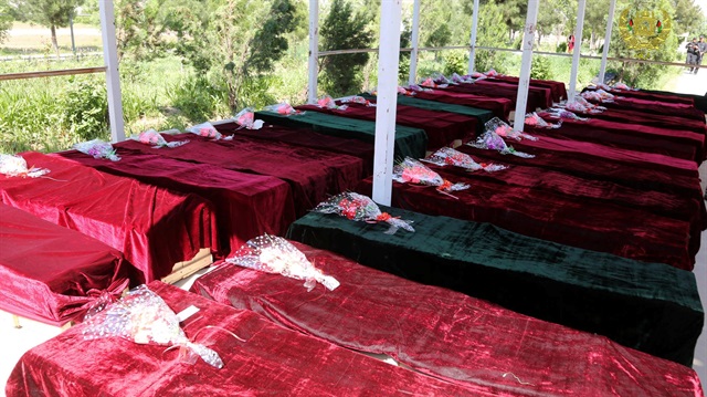 Coffins containing the bodies of Afghan national Army soldiers killed in April 21's attack