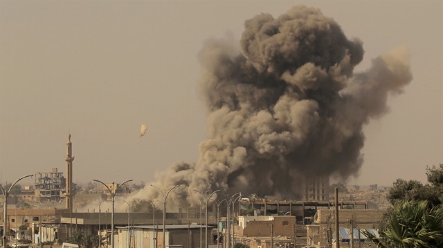 Smoke rises after an air strike in Raqqa