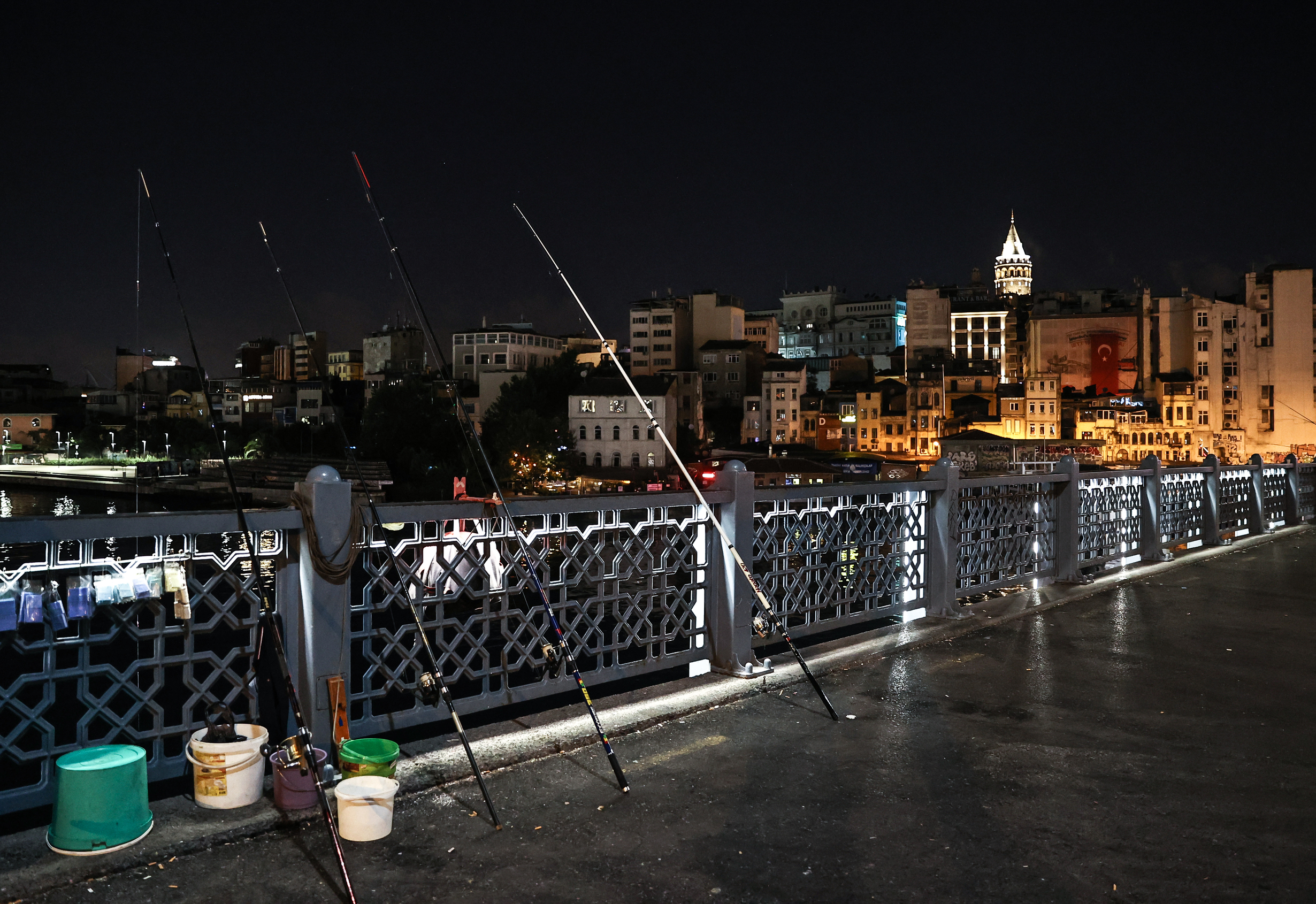 Fishermen catch fish at Galata Bridge in Istanbul