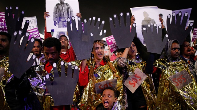 People take part in a protest against the Israeli government's plan to deport African migrants in Tel Aviv Israel