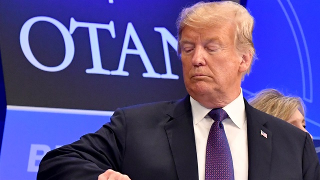 U.S. President Donald Trump checks time prior to a dinner at the Art and History Museum at the Parc du Cinquantenaire during the NATO Summit in Brussels, Belgium.