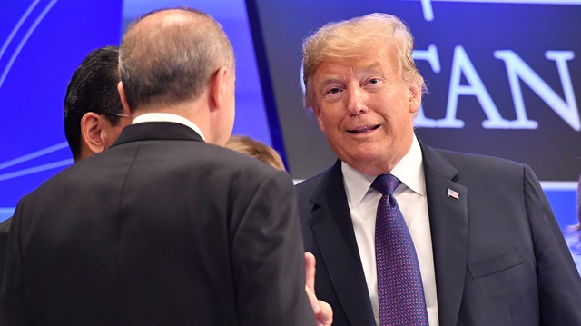 U.S. President Donald Trump talks to Turkish President Recep Tayyip Erdogan as they arrive for a dinner at the Art and History Museum at the Parc du Cinquantenaire during the NATO Summit in Brussels, Belgium July 11, 2018. 