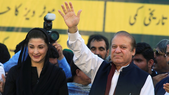 Nawaz Sharif (R), former Prime Minister and leader of Pakistan Muslim League, gestures to supporters as his daughter Maryam Nawaz looks on during party's workers convention in Islamabad, Pakistan.