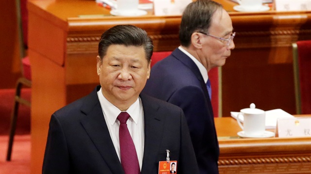 Wang Qishan, former secretary of the Central Commission for Discipline Inspection, walks past Chinese President Xi Jinping at the opening session of the National People's Congress (NPC) at the Great Hall of the People in Beijing, China March 5, 2018. 