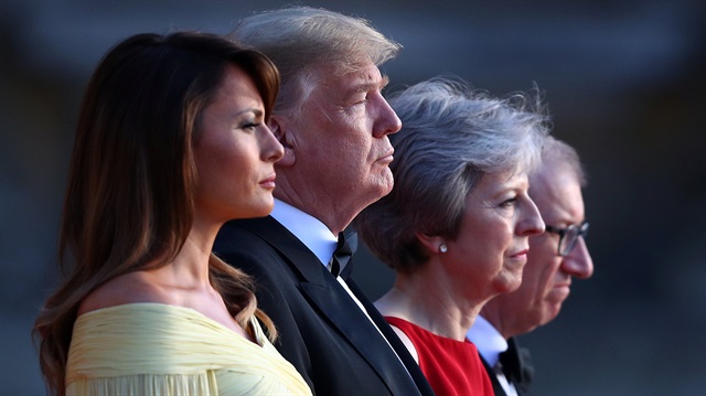 British Prime Minster Theresa May and her husband Philip stand together with U.S. President Donald Trump and First Lady Melania Trump at the entrance to Blenheim Palace, where they are attending a dinner with specially invited guests and business leaders, near Oxford, Britain, July 12, 2018. 