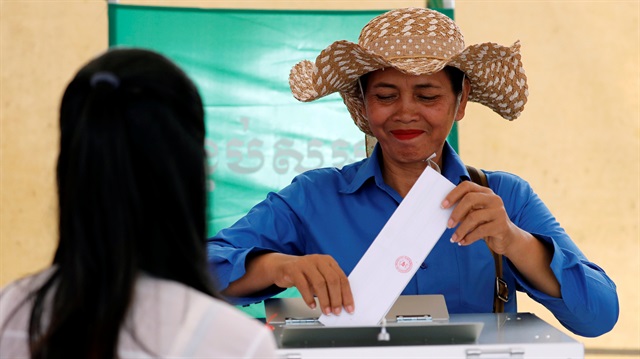 A woman casts her vote at a polling station during a general election in Phnom Penh, Cambodia July 29, 2018. 