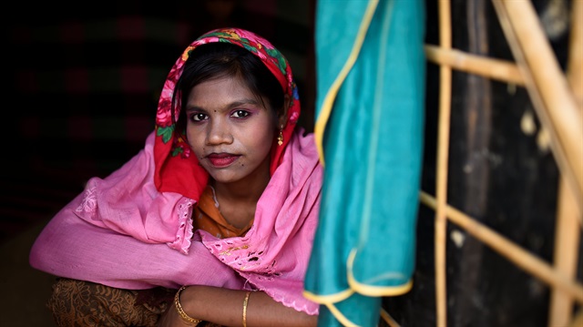 A Rohingya refugee girl named Sakila Begum, aged 15, poses for a photograph as she wears thanaka paste at Jamtoli camp in Cox's Bazaar, Bangladesh