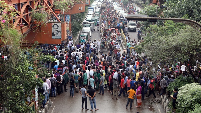 Students block a road as they join in a protest over recent traffic accidents that killed a boy and a girl, in Dhaka, in Dhaka, Bangladesh.