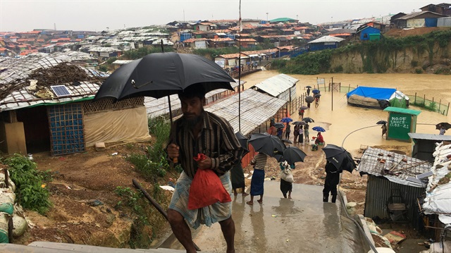 Rohingya refugees walks along the refugee camp during rain in Cox’s Bazar, Bangladesh