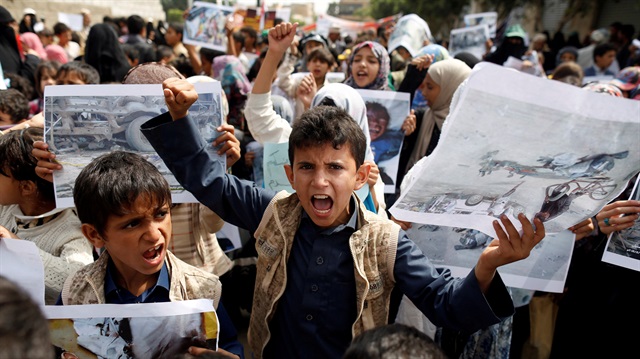 Boys demonstrate outside the offices of the United Nations in Sanaa, Yemen to denounce last weeks air strike that killed dozens including children in the northwestern province of Saada, August 13, 2018.