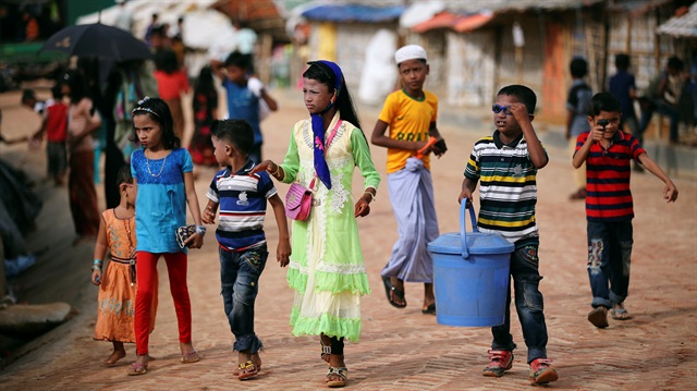 Rohingya refugee children walk in the morning wearing new clothes to celebrate Eid al-Adha in Kutupalong refugee camp in Cox’s Bazar, Bangladesh