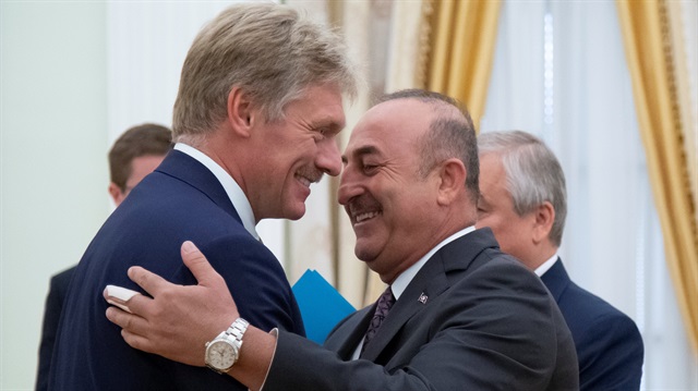 Turkish Foreign Minister Mevlüt Çavuşoğlu is greeted by Kremlin spokesman Dmitry Peskov
