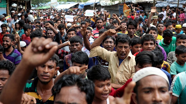 Rohingya refugees shout slogans as they take part in a protest at the Kutupalong refugee camp to mark the one year anniversary of their exodus in Cox's Bazar, Bangladesh August 25, 2018. 