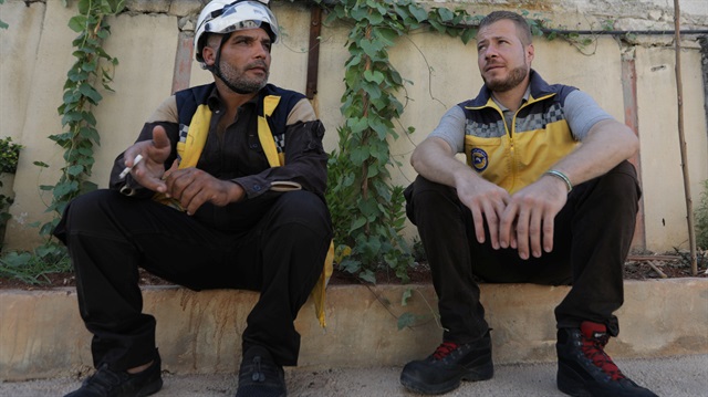 Syrian rescue worker Samir Salim sits next to his colleague Ahmed Rashid during an interview with Reuters in Azaz, Syria July 8, 2018. 