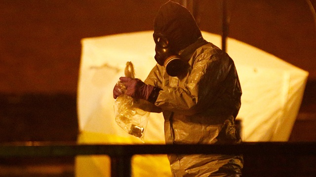 Members of the emergency services wearing protective clothing work near the bench where former Russian intelligence officer Sergei Skripal and his daughter Yulia were found poisoned in Salisbury, Britain, March 13, 2018. 