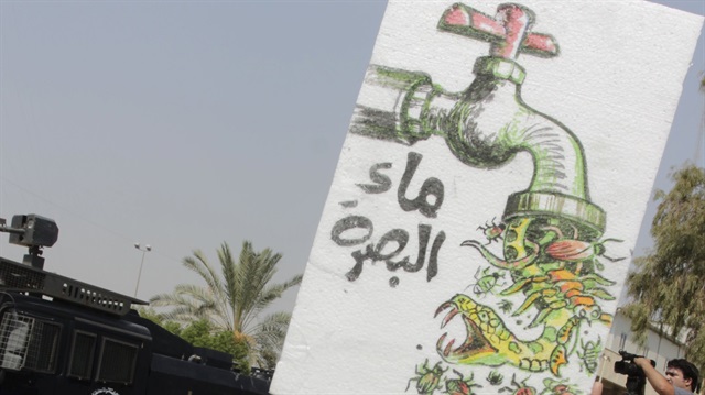 An Iraqi protester takes part during a demonstration against power cuts and water shortages 