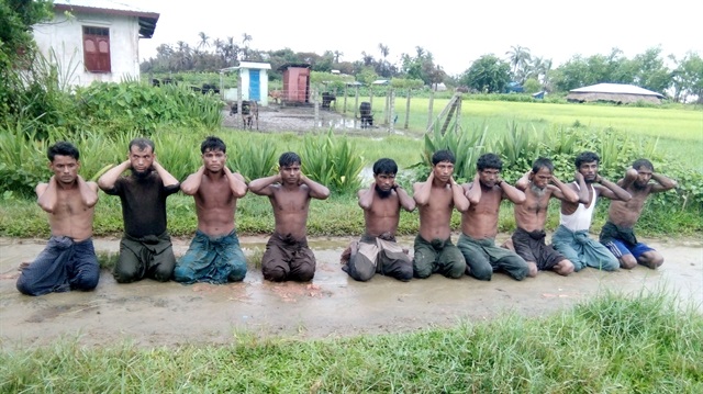 File photo: Ten Rohingya Muslim men with their hands bound kneel in Inn Din village 