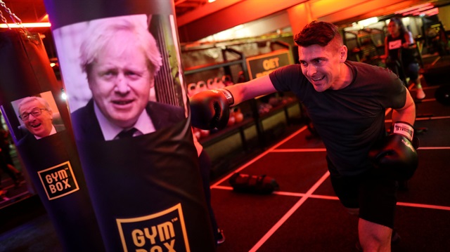 A gym member punches a boxing bag containing an image of Britain's former Foreign Secretary Boris Johnson during a Brexfit gym class at Gym Box in London, Britain September 27, 2018. 
