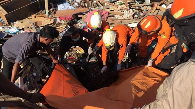 A body is recovered by Humas Basarnas in Palu, Indonesia September 30, 2018 in this picture obtained from social media. 