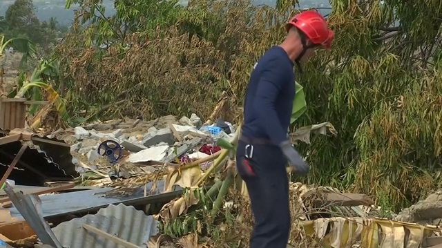 French volunteers in Indonesia search for bodies in jumbled mire