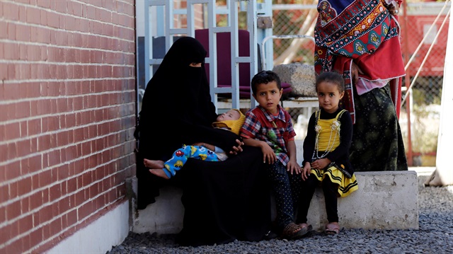 A woman and her children sits at a cholera treatment centre at the al-Sabeen hospital in Sanaa, Yemen 