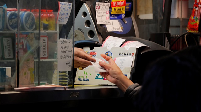 A customer purchases a ticket for the Mega Millions lottery drawing in New York City, U.S., October 19, 2018. 
