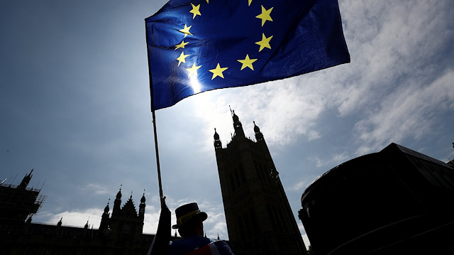An anti-Brexit protester waves an EU flag opposite the Houses of Parliament in London, Britain June 8, 2018. 
