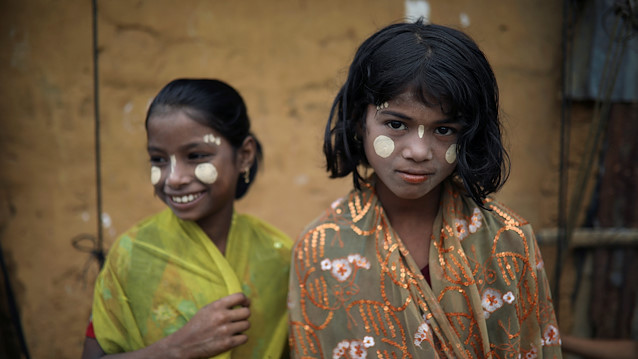 Rohingya refugee girl reacts to the camera as they apply Thanaka paste in the Kutupalong camp in Cox's Bazar, Bangladesh