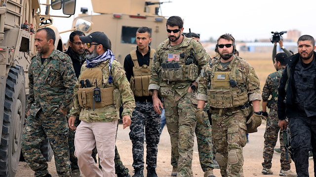 Syrian Democratic Forces and U.S. troops are seen during a patrol near Turkish border in Hasakah, Syria November 4, 2018. 