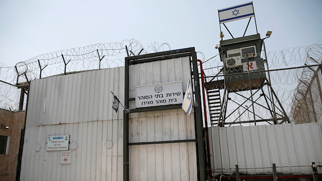 File photo: An Israeli flag is seen next to the gate of the Megiddo Prison in northern Israel