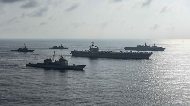 The Ronald Reagan Strike Group ship's the aircraft carrier USS Ronald Reagan (CVN 76), the guided-missile cruiser USS Antietam (CG 54) and the guided-missile destroyer USS Milius (DDG 69) conduct a photo exercise with the Japan Maritime Self-Defense Force ship's the helicopter destroyer JS Kaga (DDH 184), the destroyer JS Inazuma (DD 105) and the destroyer JS Suzutsuki (DD 117) in the South China Sea August 31, 2018.