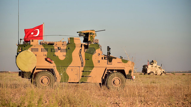 File photo: Turkish and U.S. troops are pictured during a joint patrol around Manbij