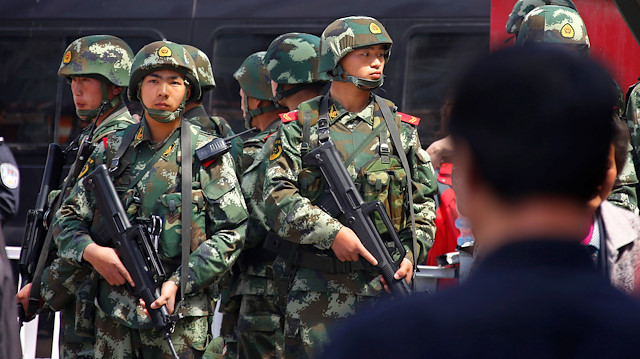Paramilitary policemen stand guard near the exit of the South Railway Station, where three people were killed and 79 wounded in a bomb and knife attack on Wednesday, in Urumqi, Xinjiang Uighur Autonomous region, May 1, 2014. 