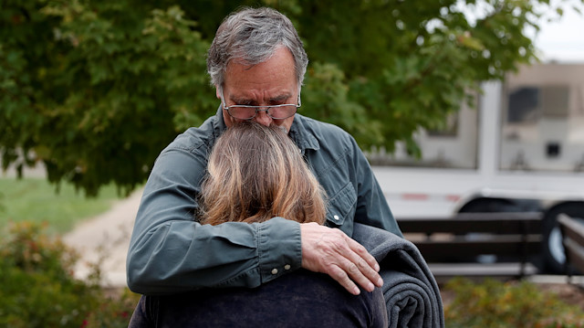 Lane Walker, of Magalia, comforts his wife, Julie, at an evacuation center for people displaced by the Camp Fire in Chico, California, U.S., November 15, 2018. 