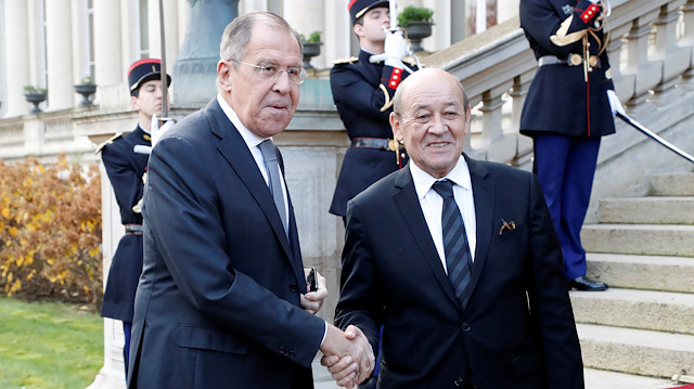 French Foreign Affairs Minister Jean-Yves Le Drian (R) shakes hands with his Russian counterpart Sergei Lavrov ahead of their meeting at the French Foreign ministry in Paris, France on November 27, 