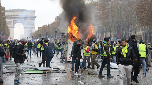Riot police use teargas against yellow vest protesters in Paris