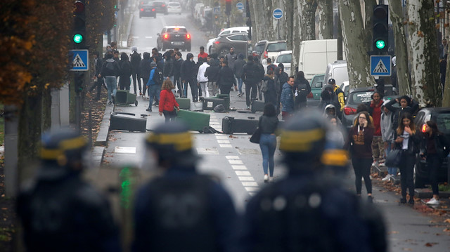 French riot police face off with youth and high school students during a protest against the French government's reform plan, in Bordeaux, France, December 6, 2018
