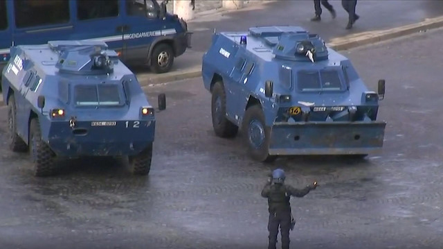 Police position armoured vehicles around Arc de Triomphe during protest