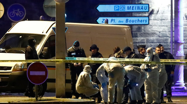 Investigators work on the street during a police operation during which the suspected gunman, Cherif Chekatt, who killed three people at a Christmas market in Strasbourg, was killed, in the Meinau district in Strasbourg, France, December 13, 2018
