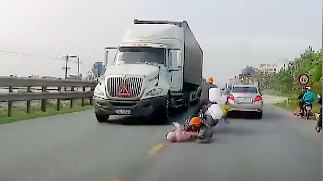 Motosikletten düşen anne ve bebeği kamyon altında kalmaktan son anda kurtuldu