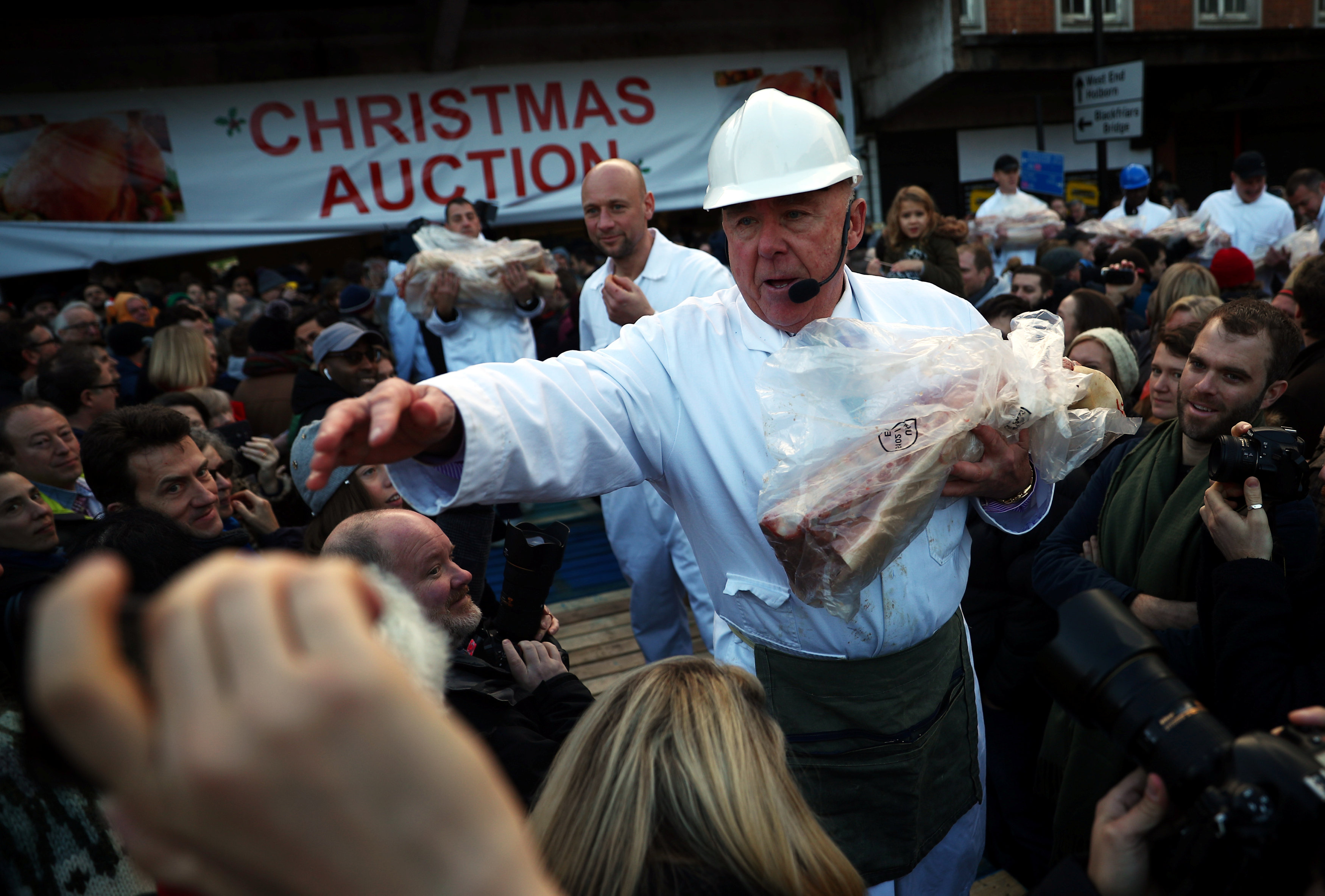 Butchers prepare to sell cuts of meat during a Christmas Eve auction in Smithfield market in London