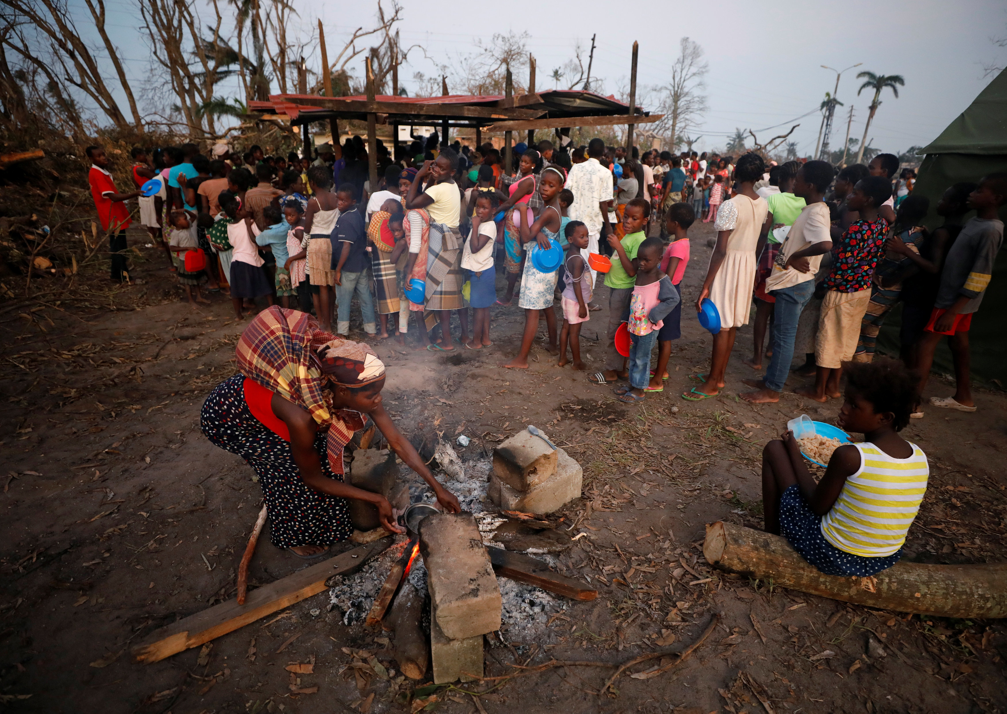 People wait for food aid in the aftermath of Cyclone Idai